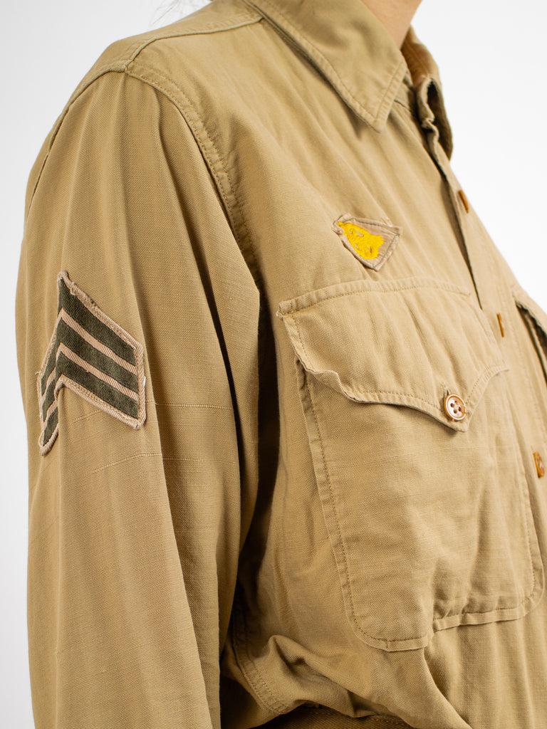 closeup of patches on khaki 1940's air force button down with two pockets on the chest