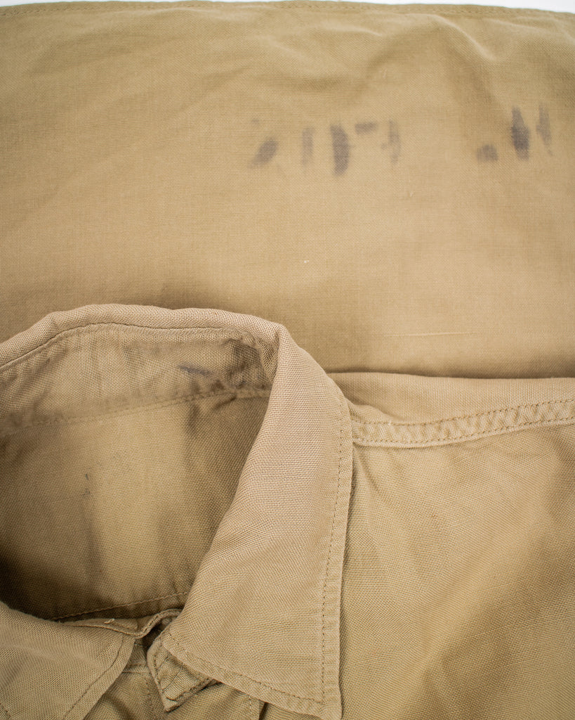 closeup showing some staining on khaki 1940's air force button down with two pockets on the chest
