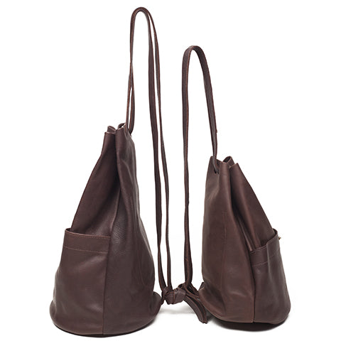 a large and small gunny sack leather backpack shown back to back in chocolate leather with a gathered strap closure and large front pocket with a stud closure, handmade by erin templeton in vancouver, canada