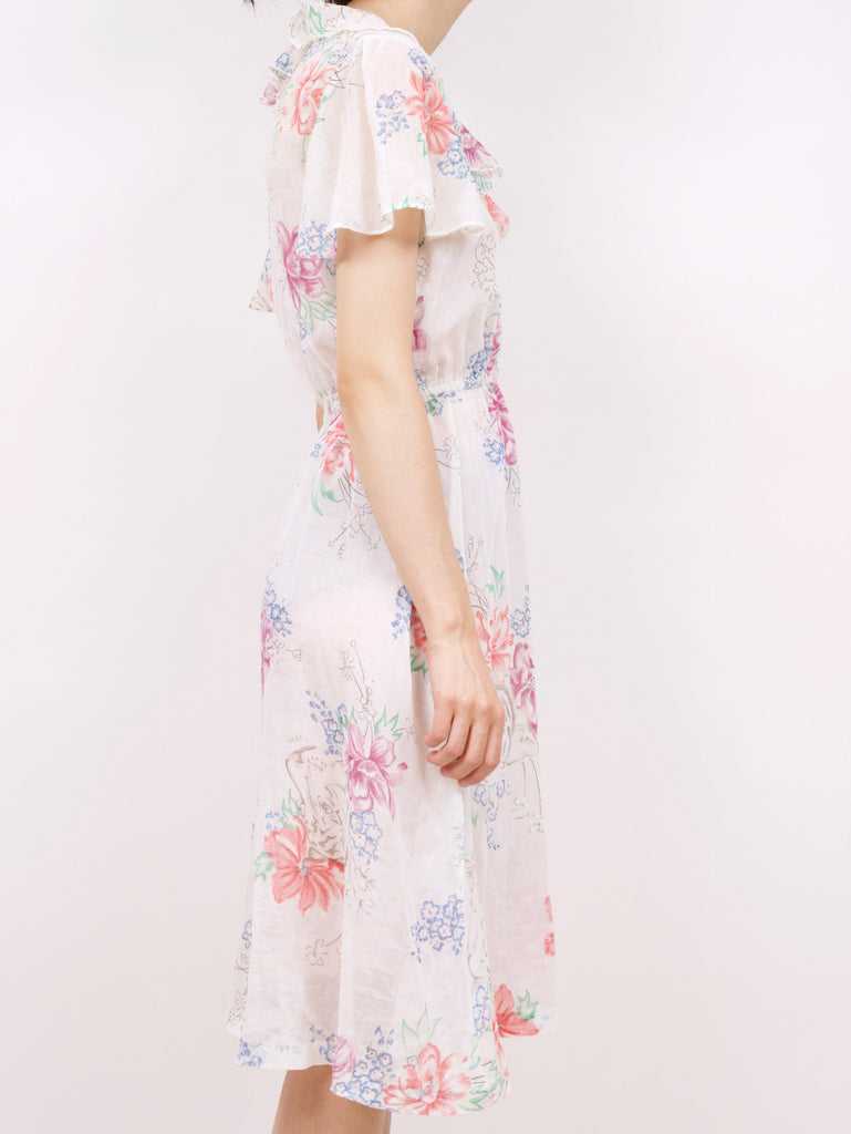 the side of a blouson style dress with a floral pattern and ruffle details